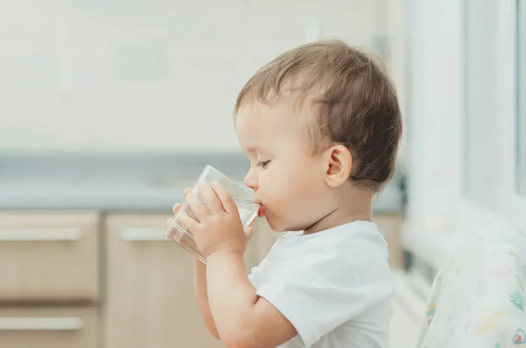 A child drinking a glass of water